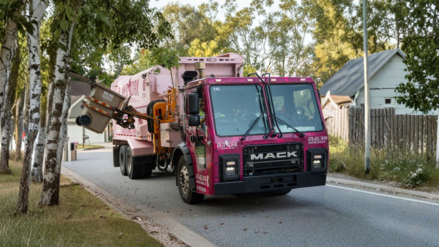 Garbage Truck Collecting Residential Trash Bins